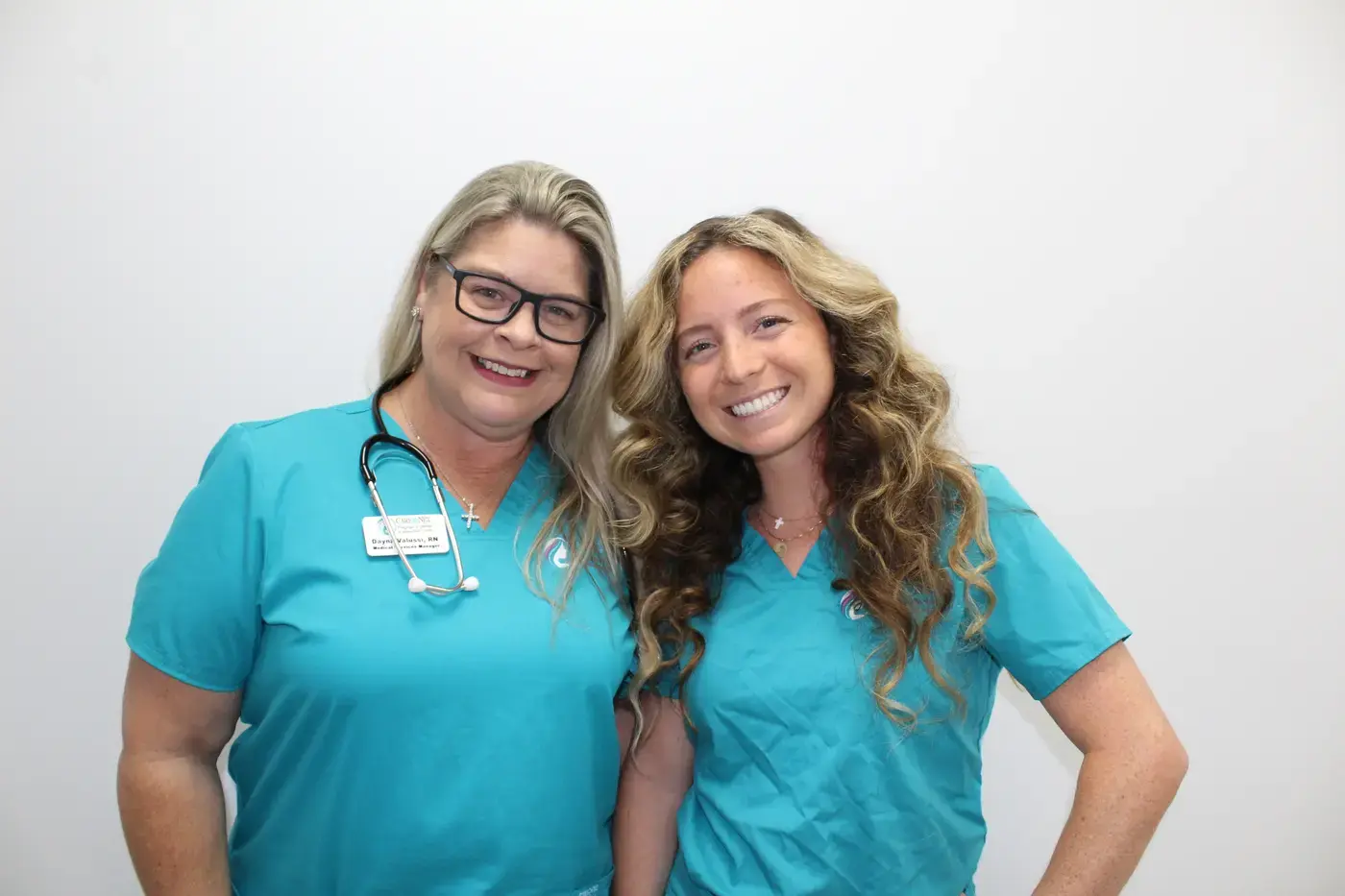 Two Care Net nurses smiling together at the Vero Beach center