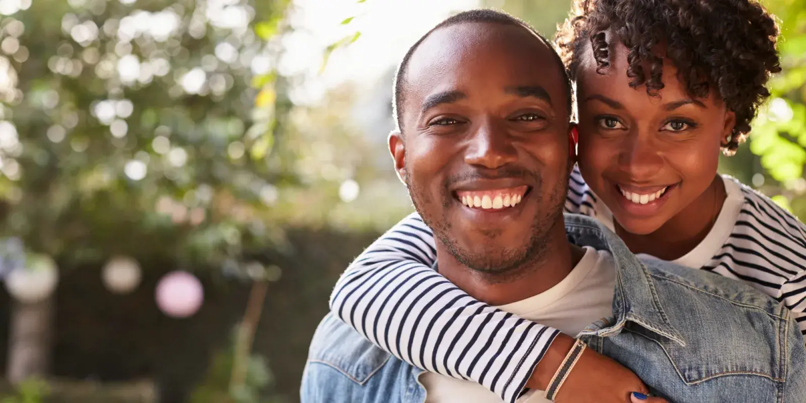 A couple smiling together outdoors
