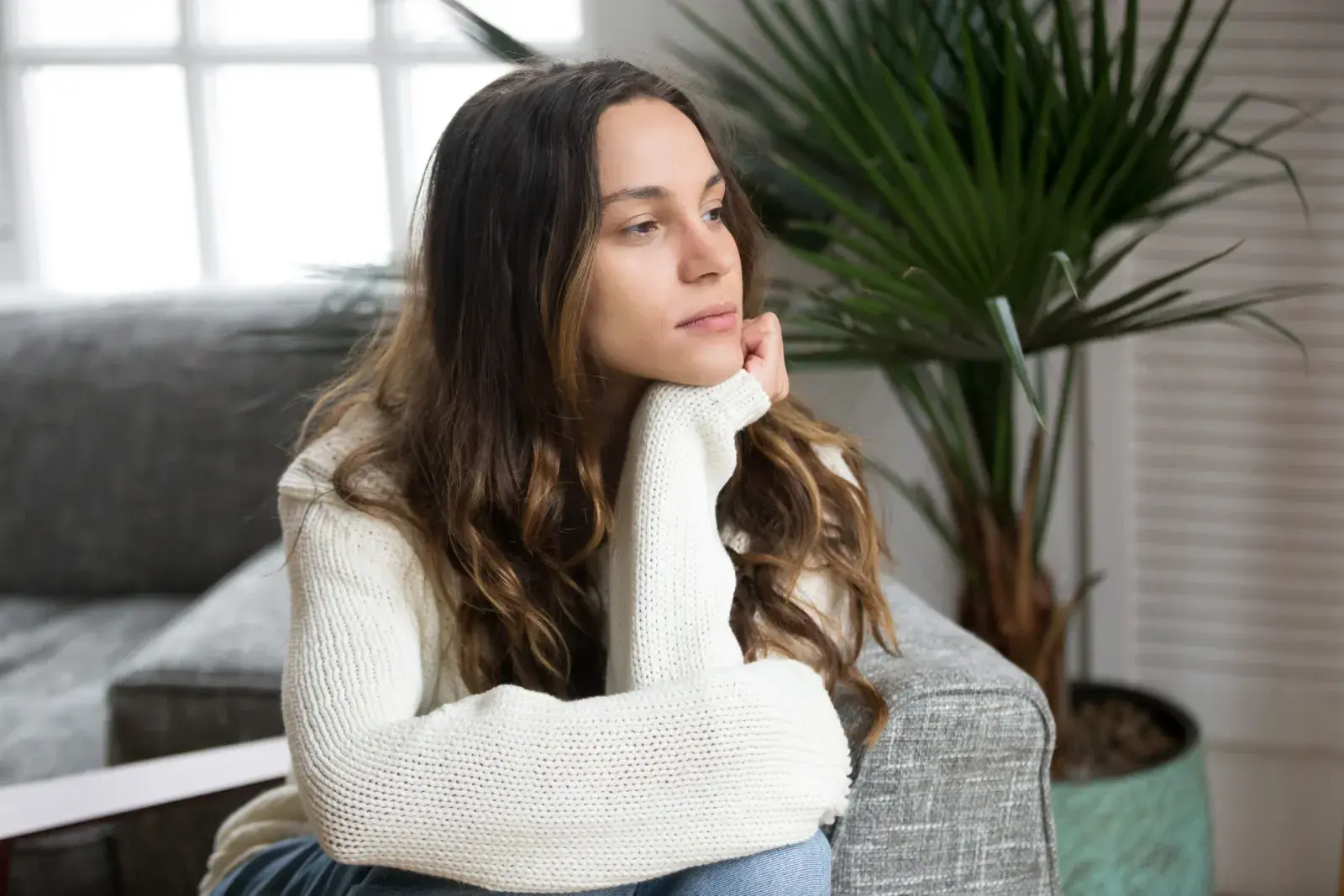 A young woman sitting in a thoughtful moment
