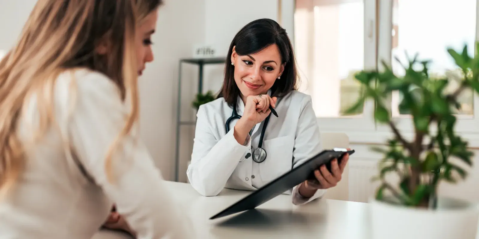 A woman having a private conversation with a clinician